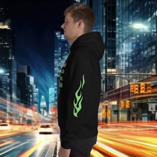 Side view of a male model wearing an oversized streetwear hoodie with flame design in a cityscape at night.