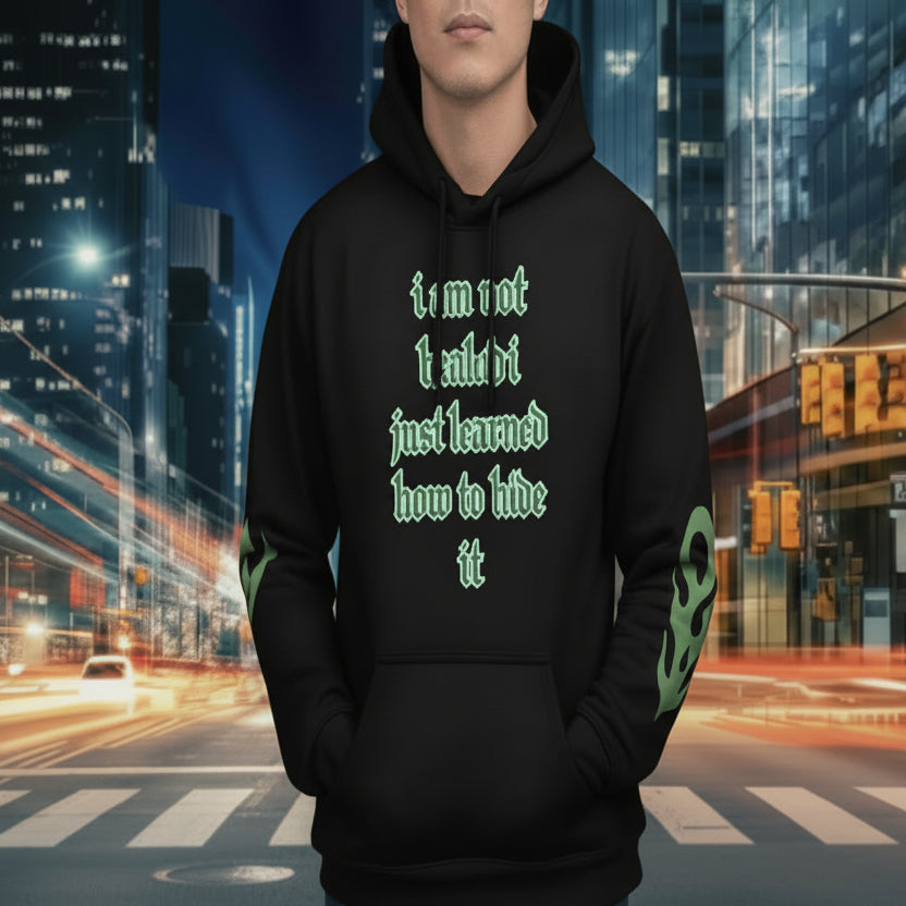 oversized urban hoodie hide it in black with green text, urban background, stylish streetwear, statement piece