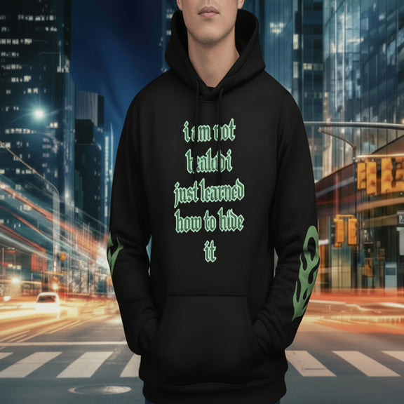 oversized urban hoodie hide it in black with green text, urban background, stylish streetwear, statement piece