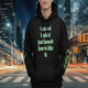oversized urban hoodie hide it in black with green text, urban background, stylish streetwear, statement piece