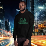 Model wearing oversized streetwear hoodie "warrior" with text "I'M A SILENT WARRIOR" in an urban night setting.