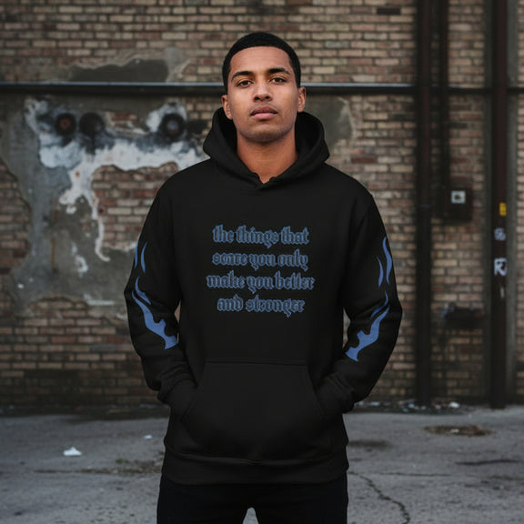 Oversized streetwear hoodie with motivational quote on a model against an urban background.