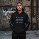 Oversized streetwear hoodie with motivational quote on a model against an urban background.
