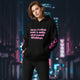 Model wearing an oversized streetwear hoodie with a motivational quote and flame graphics in an urban setting.