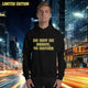 oversized streetwear hoodie 'be better' worn by a model in an urban setting with bright city lights.