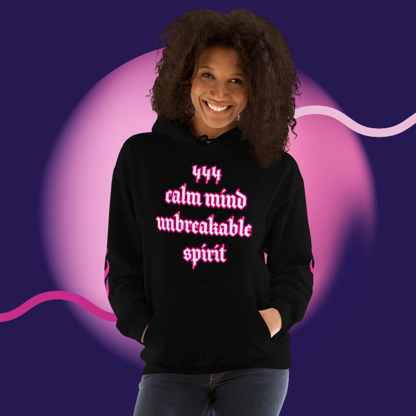 Woman wearing an oversized streetwear hoodie 444 with 'calm mind unbreakable spirit' design on a colorful background.