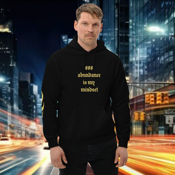 Man wearing oversized hoodie 888 streetwear with the phrase '888 abundance is my mindset' in a city backdrop.