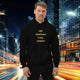 Man wearing oversized hoodie 888 streetwear with the phrase '888 abundance is my mindset' in a city backdrop.