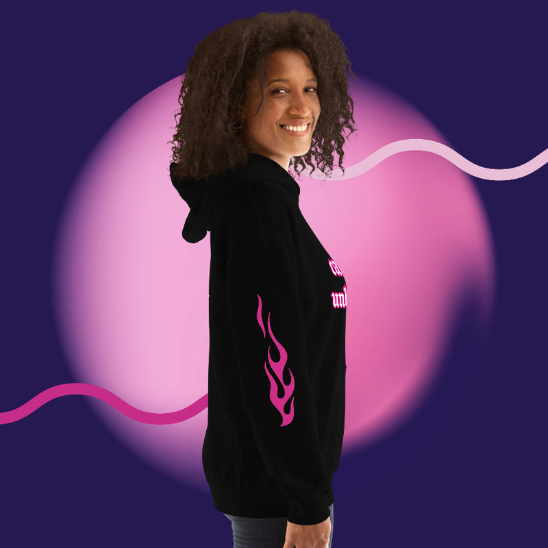 Smiling person wearing oversized streetwear hoodie 444 with pink flames design against a colorful background.