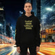 Oversized streetwear hoodie with 'I must not fear. I will face my fear' mantra in a city at night.